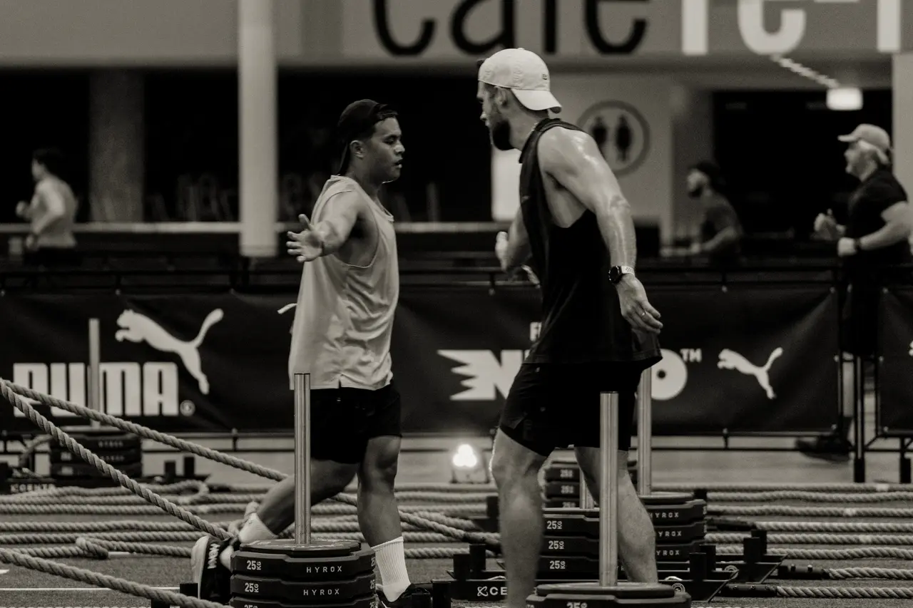 HYROX injury care in Toronto: two athletes training with weighted sleds