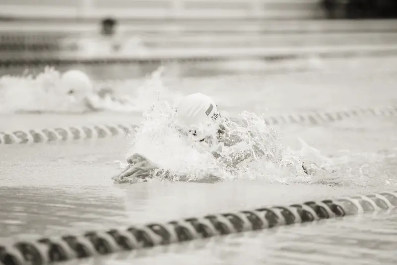 Swimmer mid-stroke in a lane