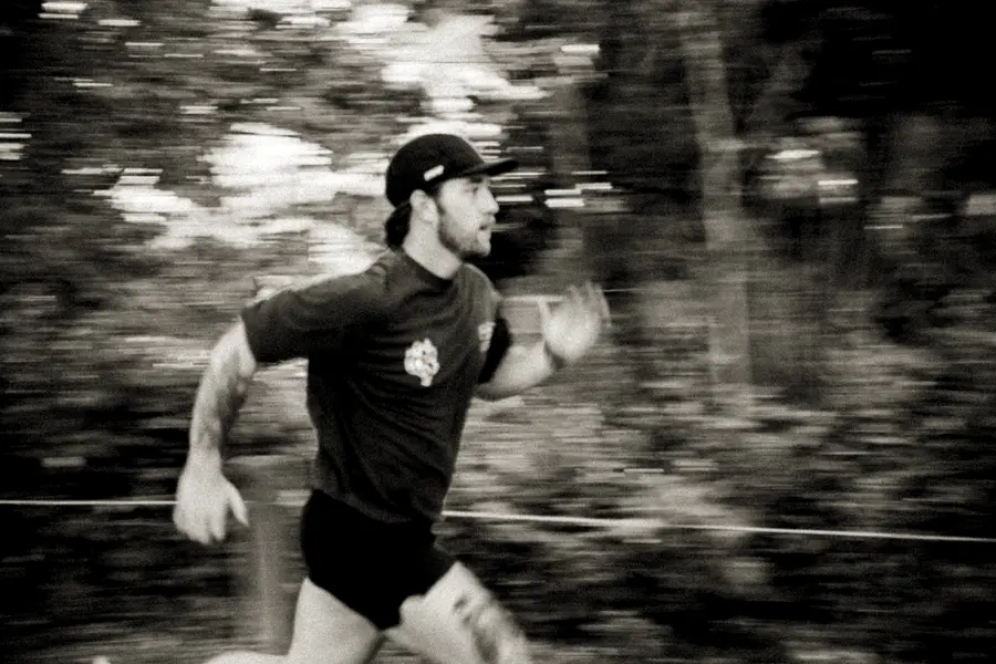 Runner pushing the pace on a trail